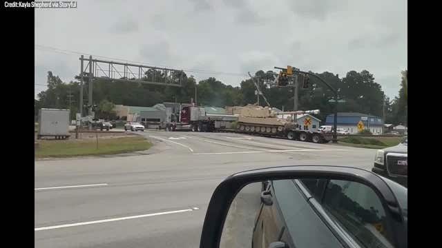 Watch: Train slams into semi carrying military tank