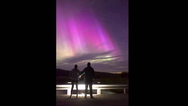 Watch magical moment man proposes under dreamy purple aurora