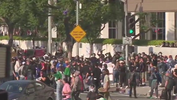 LA protests: Riot gear distributed by masked group sparks questions