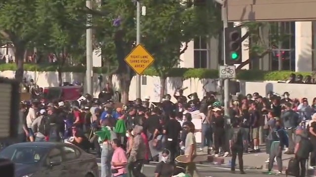 LA protests: Riot gear distributed by masked group sparks questions