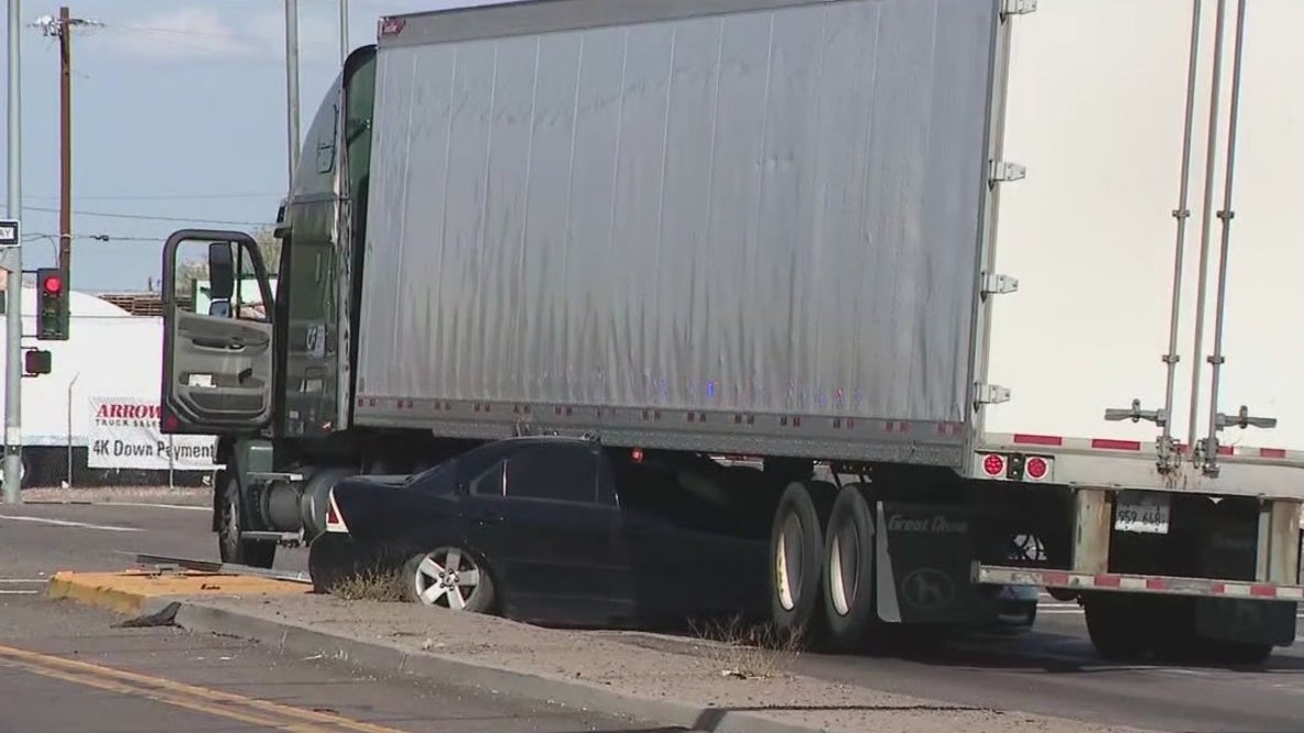 Car crashes into semi, gets wedged underneath