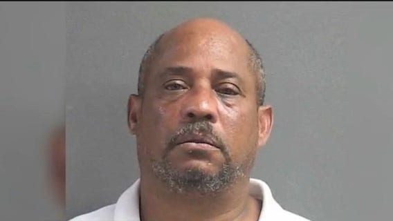 Man accused of pointing gun at kids at bus stop