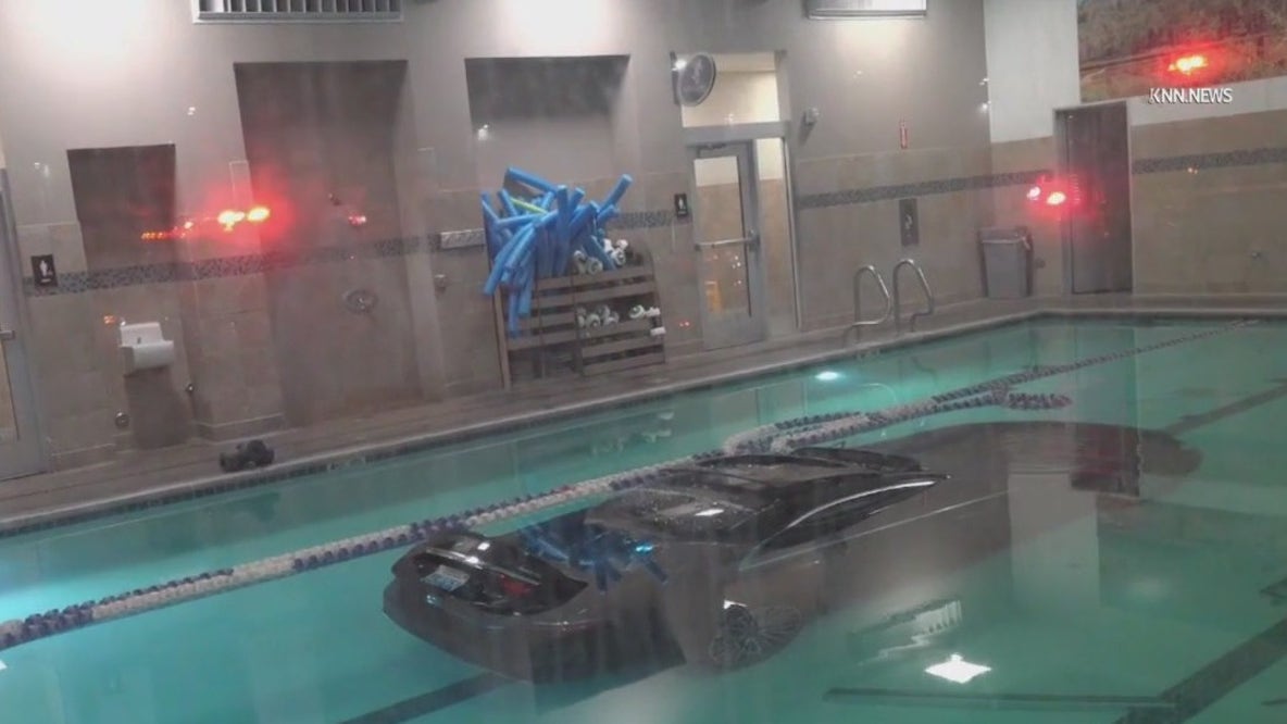 Person drives car into gym swimming pool