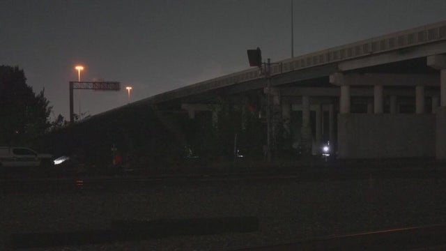 Man found on fire, hanging from rope under I-610 freeway; HPD investigating