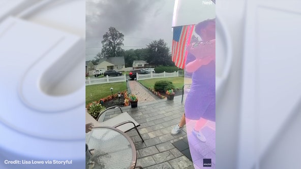 Watch: Delivery driver has close call after lightning strikes near New Jersey home