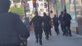 Photographer captures police chasing armed suspect into San Francisco BART station, shots fired