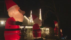 Suburban street lined with inflatable Santas for holiday season