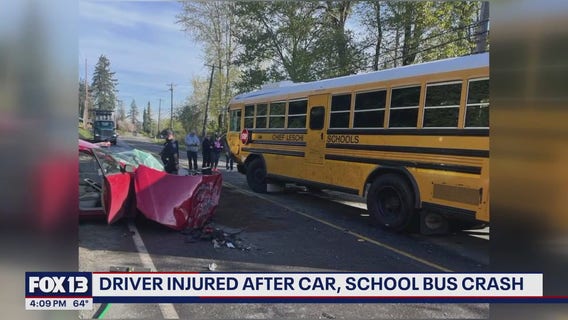 Driver injured after car, school bus crash