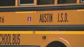 Woman arrested after crashing into AISD buses