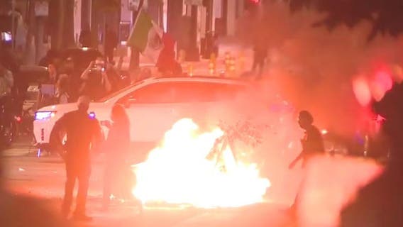Fireworks go off, bonfire set in front of cops