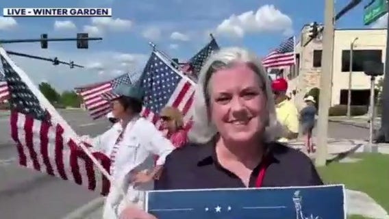 Residents wave flags to celebrate U.S. Army's birthday