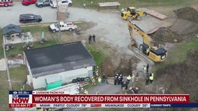 Woman's body recovered after falling in sinkhole