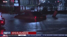 Car stuck in flooded roadway in Titusville