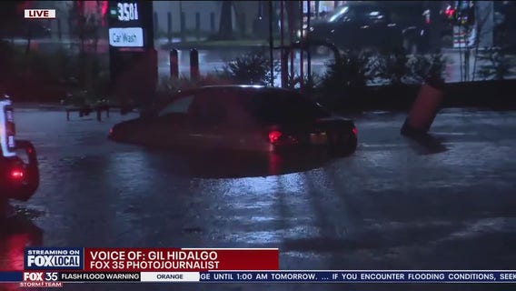Car stuck in flooded roadway in Titusville