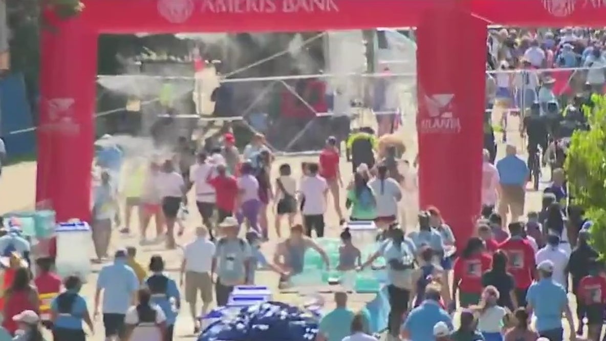Runners cross the Peachtree Road Race finish line