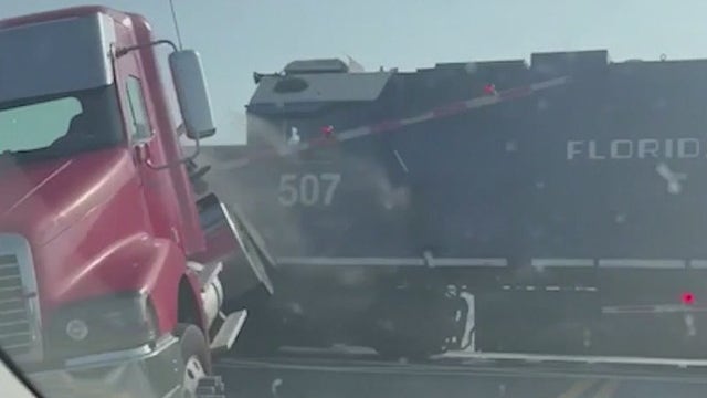 Freight train slams into semi-truck stalled on tracks in Florida