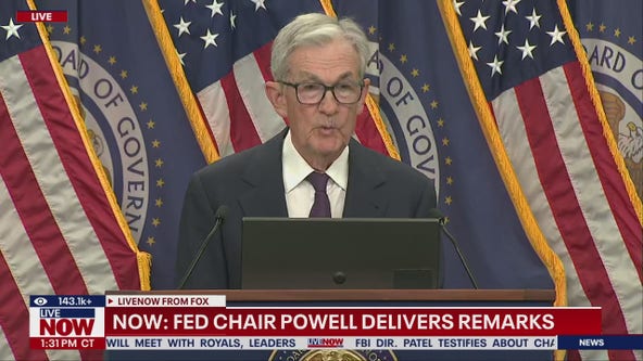 Fed cuts key interest rate, signals two more this year