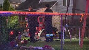 Elderly driver crashes through Canton garage, hits man in backyard