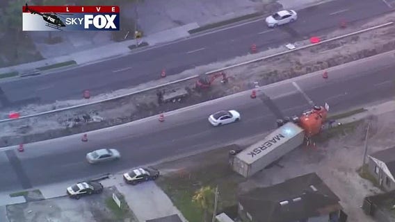 Semi-truck runs off road, overturns in Pine Hills