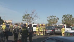 Vehicle strikes two in parking lot