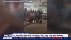 Helene’s fast rising flood surge leaves neighbors standing in chest-deep brown water inside home