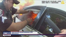 Dramatic video shows first responders saving man from burning car