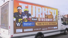 UM players Semaj Morgan and Will Johnson help with Thanksgiving turkey giveaway in Detroit