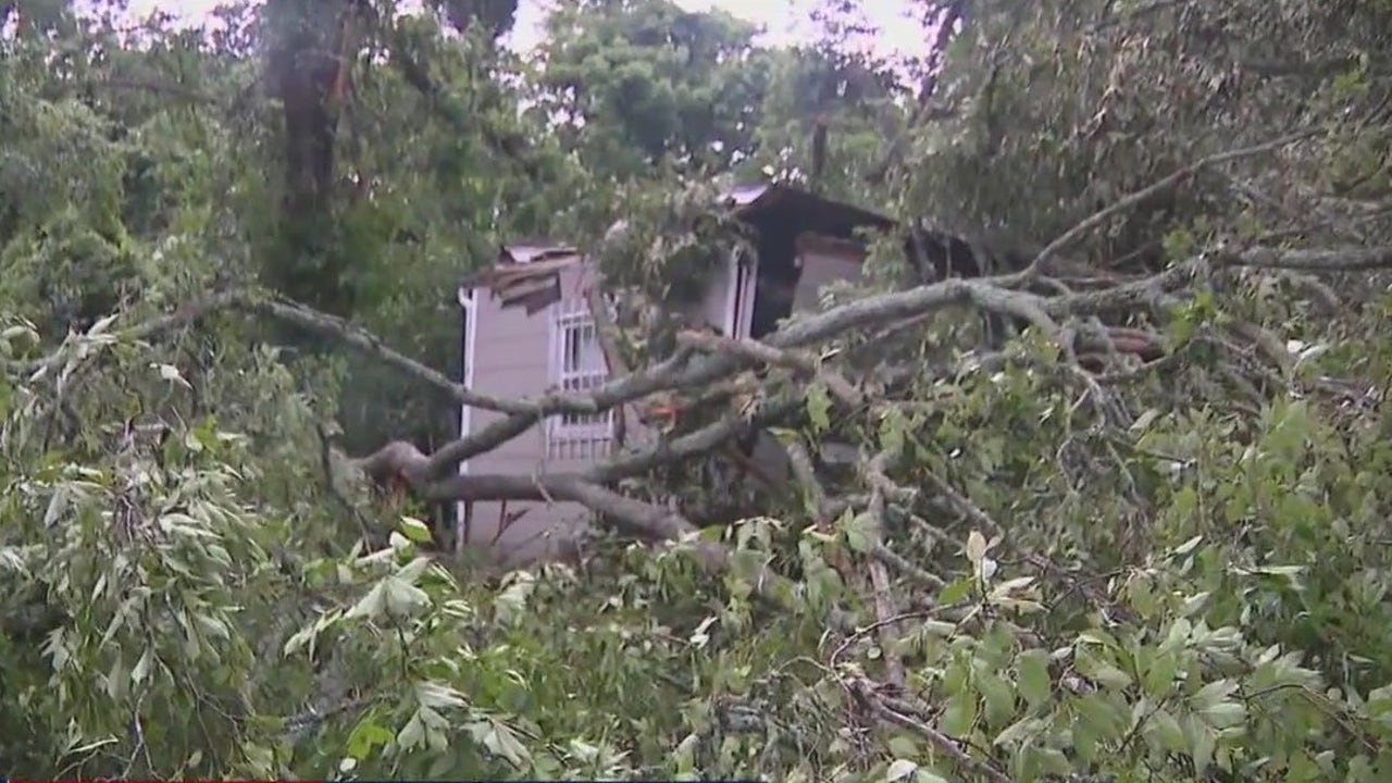 Tree crash on Atlanta home, traps man inside