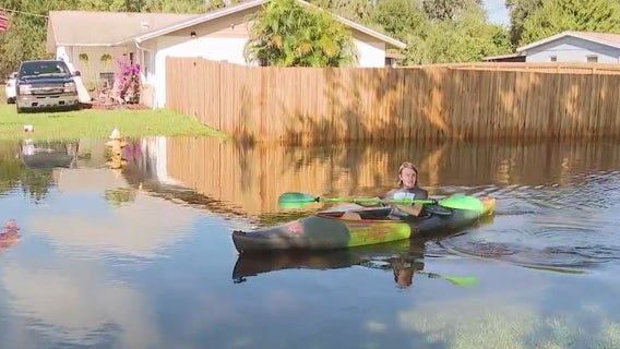 Titusville resident kayaking in floodwaters