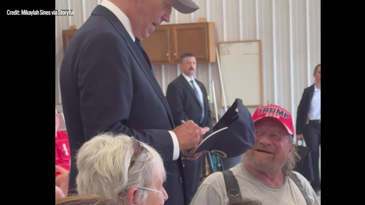 Biden dons Trump hat, jokes about eating cats and dogs