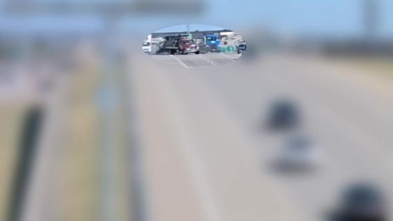 VIDEO: Crash leaves tow truck dangling off overpass