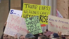 Federal workers protest outside Tesla showroom in San Francisco; Musk defends cuts