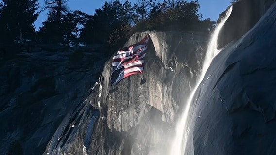 ‘Distress flag’ flies over Yosemite to protest cuts as crowds view firefall