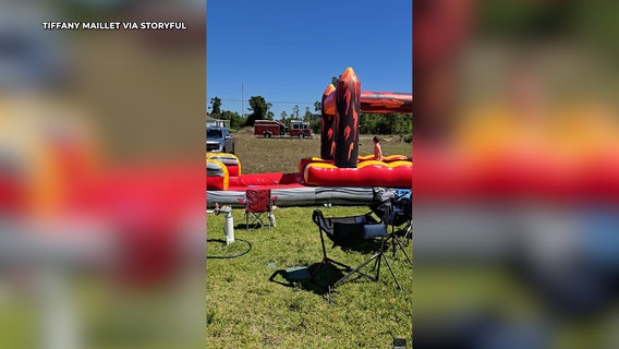 Firefighters make kids' day by hosing down bouncy slide