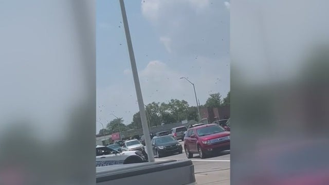 Helicopter rains cash onto Detroit street in honor of respected community member