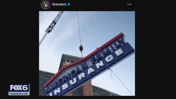 Crews work to place 52,000-pound sign on American Family Field