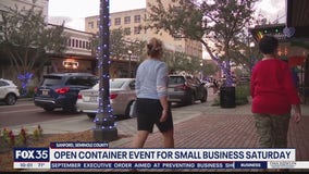 Sanford holding open container Small Business Saturday