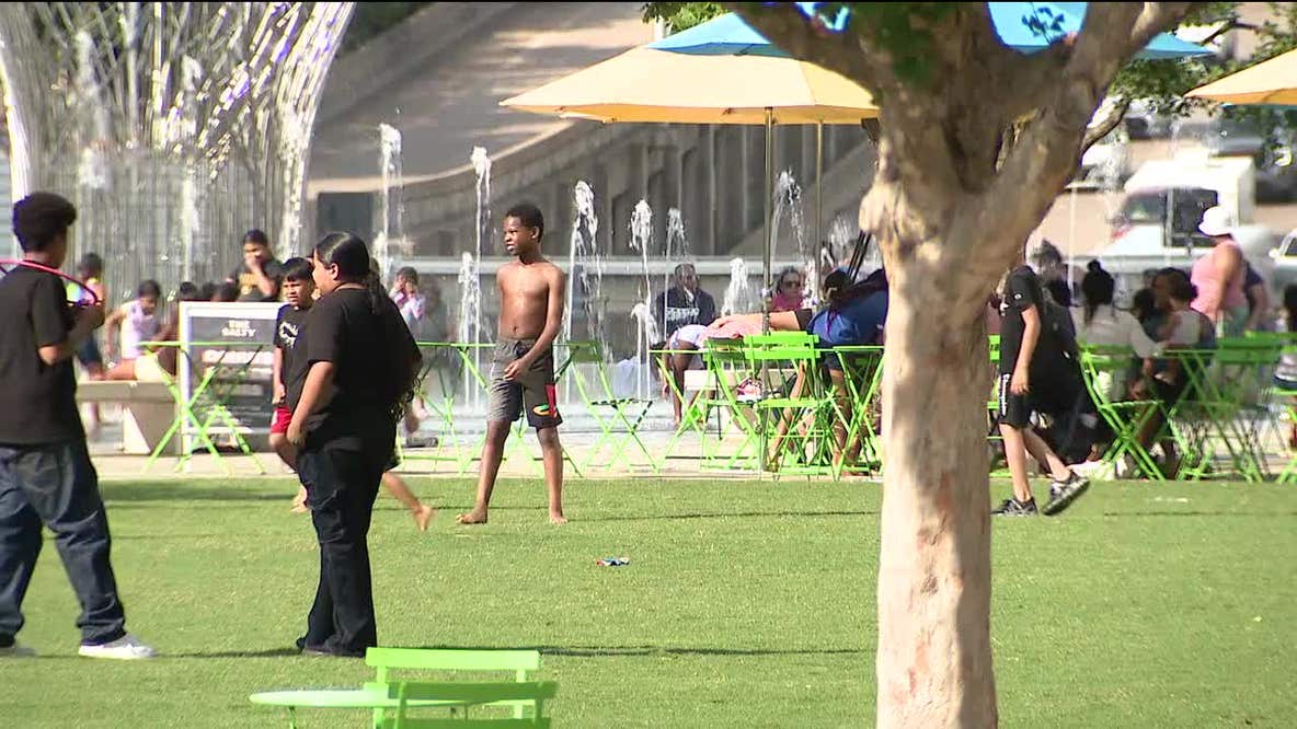 Dallas residents beat the heat, on watch for storms
