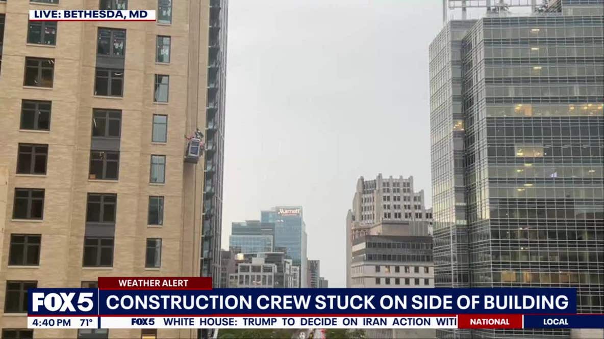 Construction worker appears to get stuck from side of building