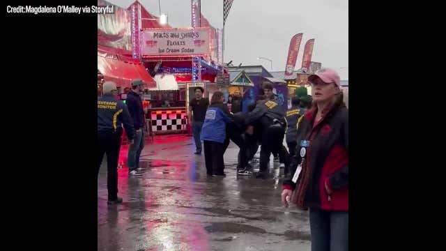 Watch: 'Heroic' man wrestles gun from brawling fairgoers