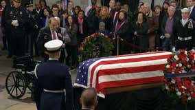 Bob Dole salutes George H. W. Bush's casket