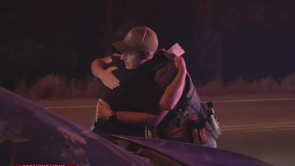 Park ranger comforts man during Bridge Fire