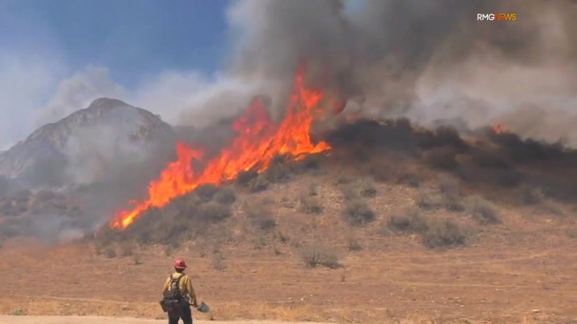 Fire rages amid triple-digit temps