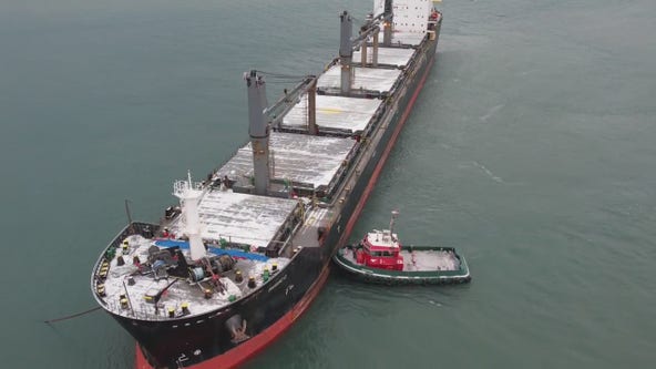 Freighter stuck in Detroit River, tugboats work to pull it free
