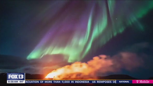 Northern lights shine over Iceland's erupting volcano