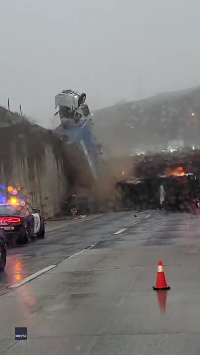 Truck tumbles over freeway overpass in California
