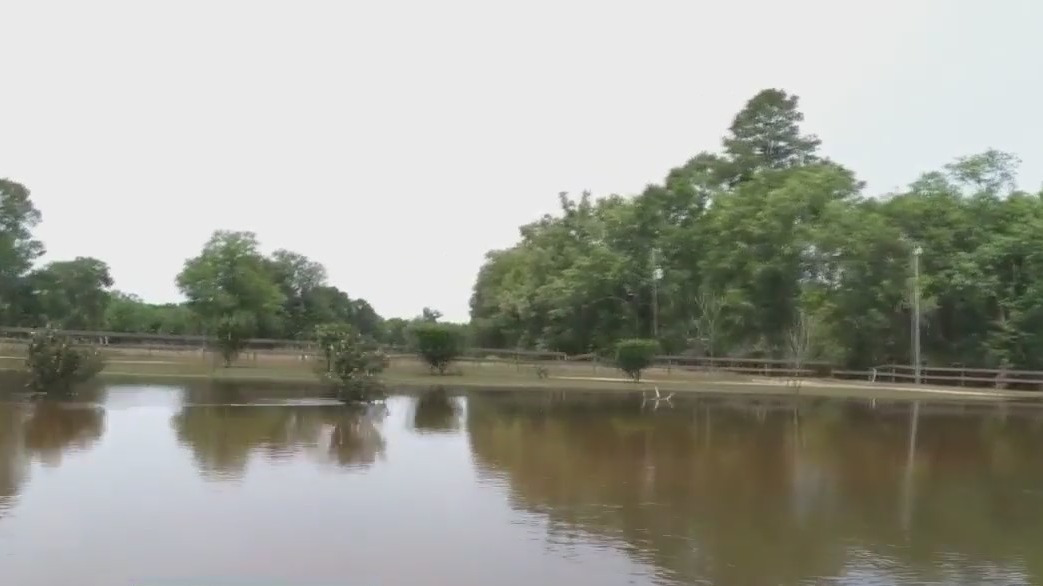 Residents boating home following flooding rains