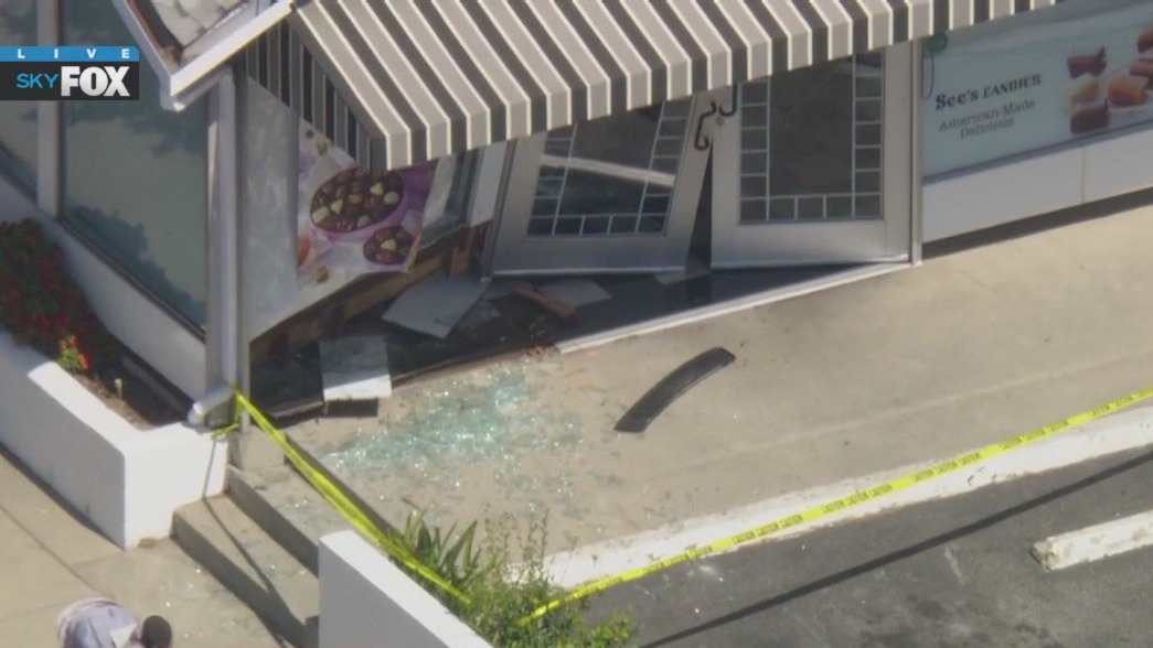 Car slams into See's Candies store