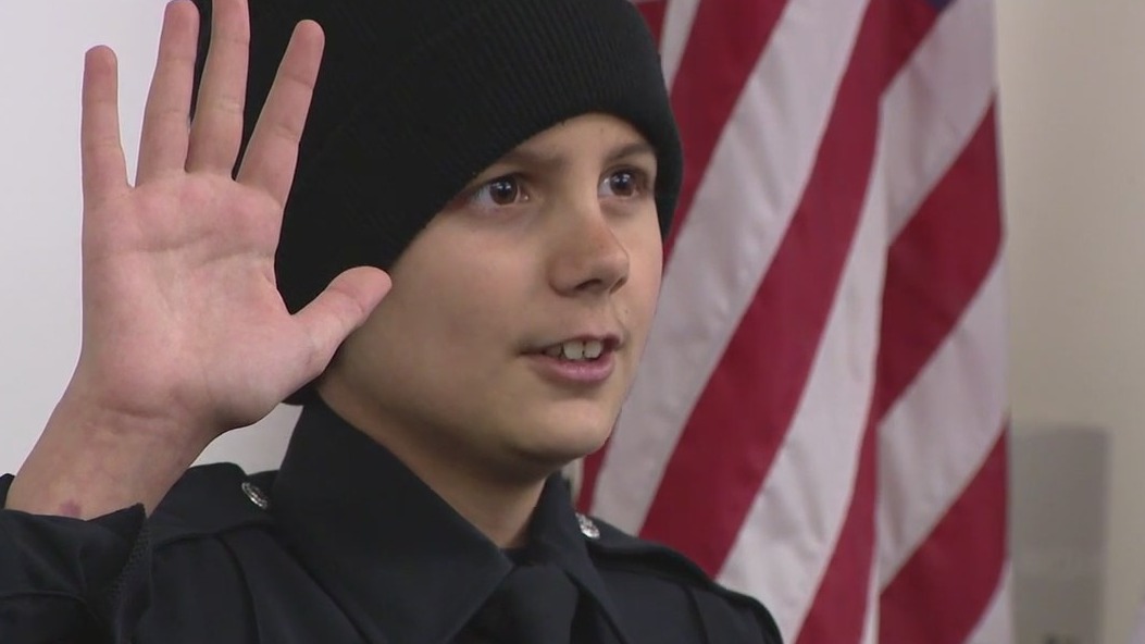 Boy fighting rare form of cancer becomes honorary officer