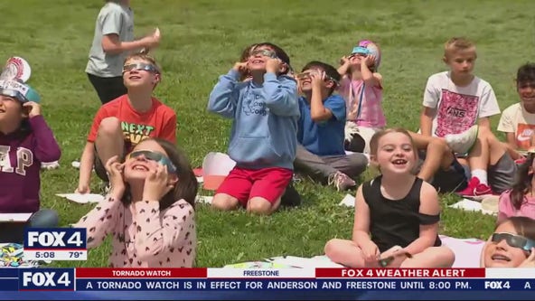 Families enjoy watching solar eclipse together